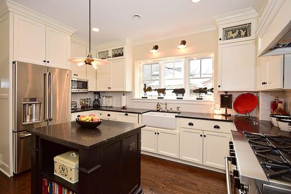 Full overlay white perimeter with 2-tier cabinets.  Dark Hickory island.