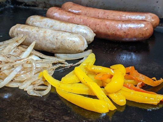 Bratwurst & Kielbasa links on the flat top to brown off. I only use tri-colored peppers (never green) on my sausage & pepper sandwiches.