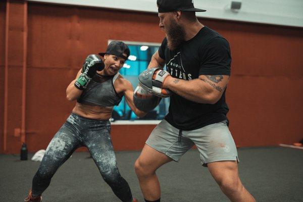 Boxing training: 2x world champion boxer Maureen Shea hitting pads with coach Phil Daru getting ready for a third title fight.