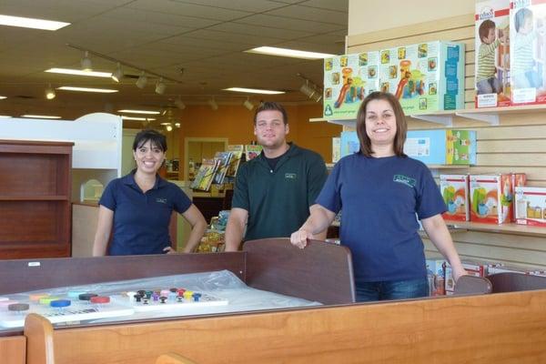 Staff cleaning contents after a fire at Baby Stop in Scottsdale