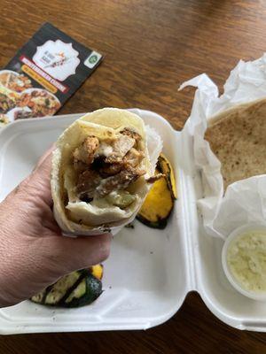 Closeup of fantastic Chicken Shawarma wrap sandwich with pickles and garlic sauce. You have got to try this!!!