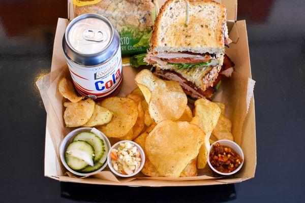 Boxed Lunch with chips, a Northern Soda, and cookie.