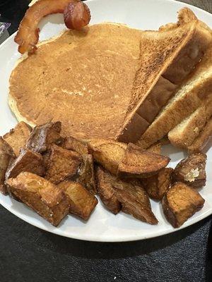 Pancake with home fries, toast (from omelette meal) and bacon.