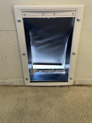 Dog door does not open or shut properly due to extra insulation and spray foam protruding into door.