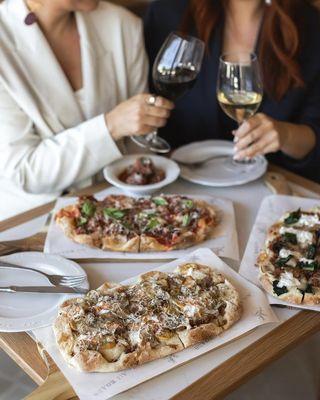 A variety of pinsa, Roman-style flatbreads, including our sausage and porcini, rossa, and amatriciana pinsa.