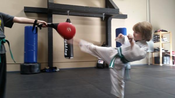 Cannon Starritt, age 6 doing a round house kick at Revolution Ryu dojo.