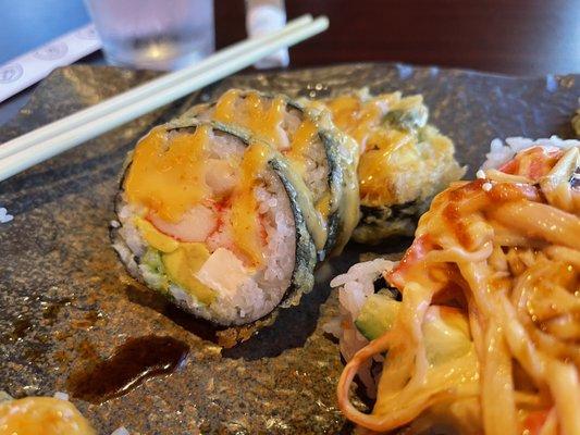 Ocean Roll (tempura crab, yellowtail, avocado, crème cheese, topped with aioli mayo)