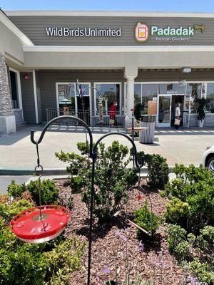 Several types of bird feeders stood up just in front of the business