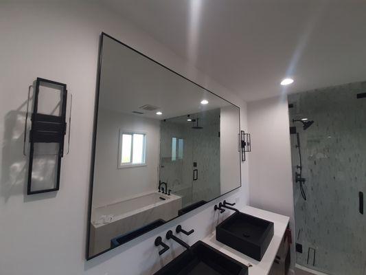 Custom framed matte black 'L' channel framed mirror installed.