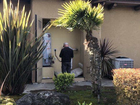 Kris Miller checking out the water heater on a home inspection.