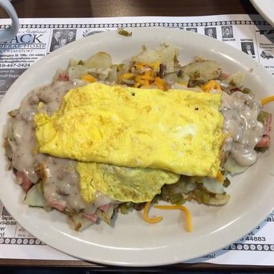 "Bob's The Mess" scrambled eggs on top of home fries, ham, cheddar cheese, mushrooms, onions and peppers, smothered with sausage gravy.