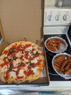 A Margherita pizza and some sides for Yelp's Big Night In. This pizza is much better with the thin crust.