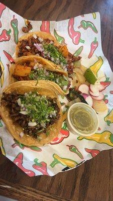 2 Al Pastor tacos with pineapple and a steak taco.