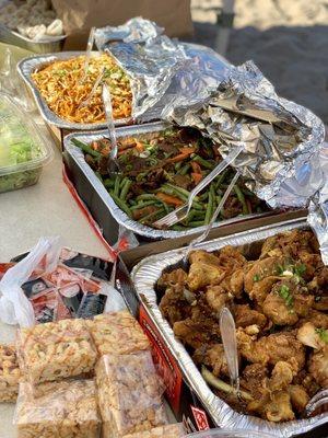 Full trays of Chow Mien, Green Beans Beef, and Black Pepper Chicken