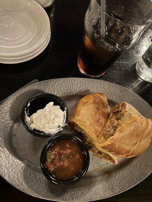 Carne Adobada.  Served with sour cream and salsa.  Crust is delicious.