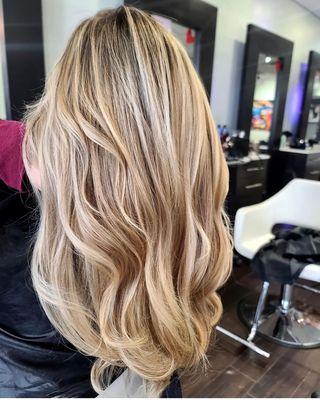 this is a balayage some low lites with a shades shadow root and layers with waves