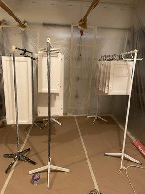 Drying racks in a garage plastic spray booth.