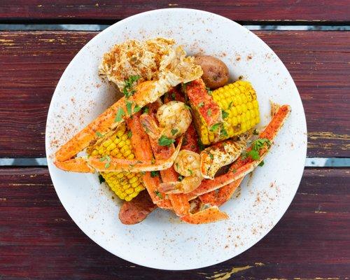 Seafood Boil ~ A Delicious Blend of Crab Legs, Shrimp, Andouille Sausage, Corn, Potatoes in Creole Sauce with Toasted French Bread.