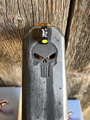 Punisher skull engraved, eyes cut thru slide to show barrel.  Glock