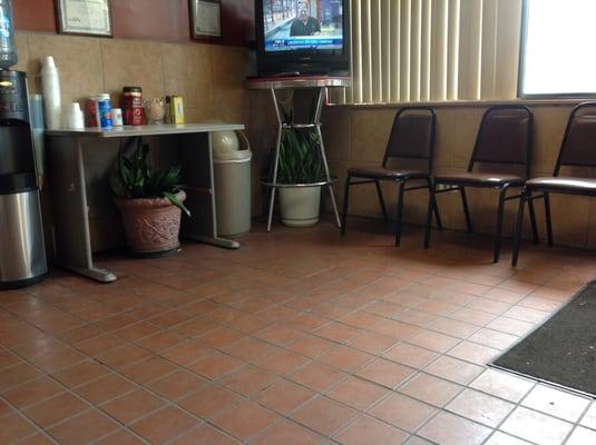 Waiting area with free coffee and TV