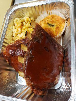 Combo...Ribs and chicken with macaroni and cheese and a corn muffin