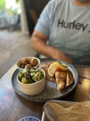 Special Tripletail entree with petite garlic parmesan potatoes and broccoli with jalapeño cheese.