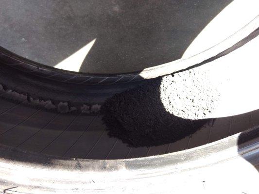 Melted bits of rubber inside sidewall warranting tire replacement