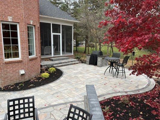 Large patio with custom steps out of each door. A built in gas fireplace and grill island really set this project off.