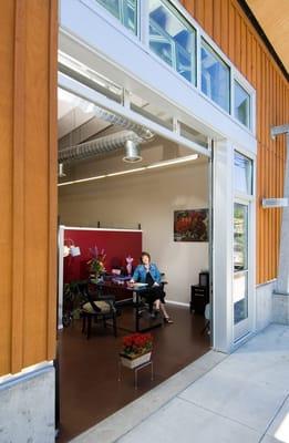 The abundance of windows blend the office into the street scene and encourages interaction with passerby and walk-in clientele.