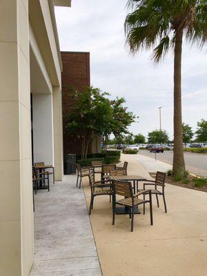 Outdoor front patio seating that's partially covered with outlets.