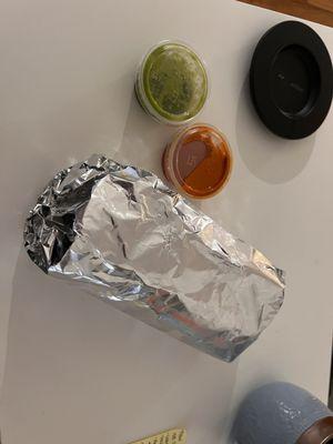 Al pastor burrito with green and red hot sauce