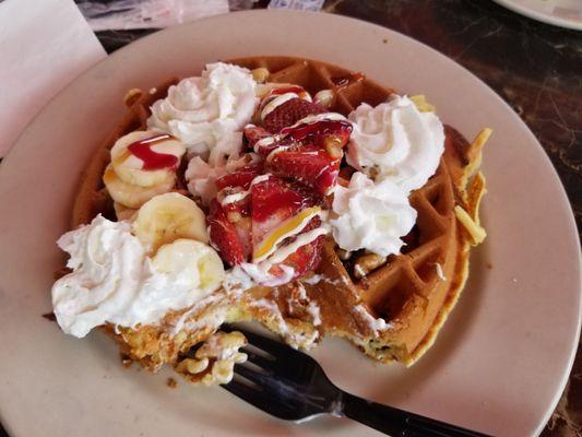 Royal waffle includes banana strawberry whipped cream and walnuts.