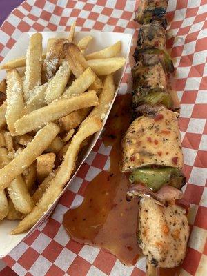 Chicken kabob with jerk sauce and garlic truffle fries