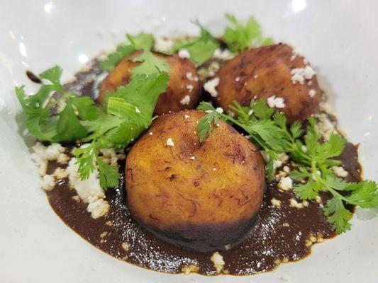 Molotes de platano. Plantain balls in mole.