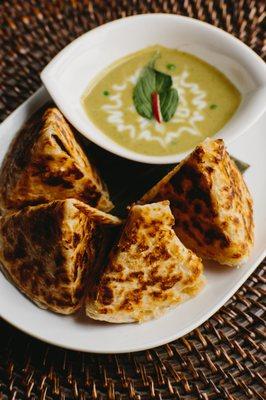 Roti bread with green curry dipping sauce