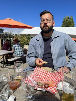 My partner finishing his last bites of pupusas, sitting on the patio.