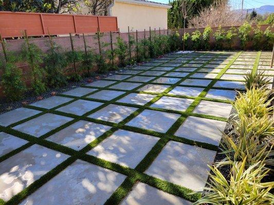 Concrete installation with turf in joints and landscape