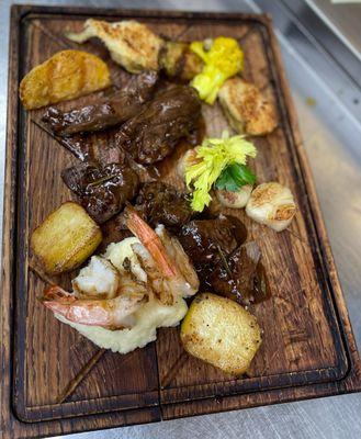 Delicious Surf n' Turf Platter Served with Grilled Shrimp, Scallops, Filet Mignon and Roasted Potatoes