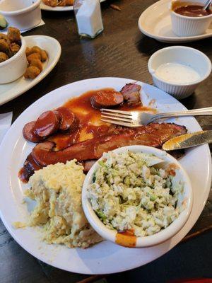 German sausage, sliced brisket, potato salad and coleslaw