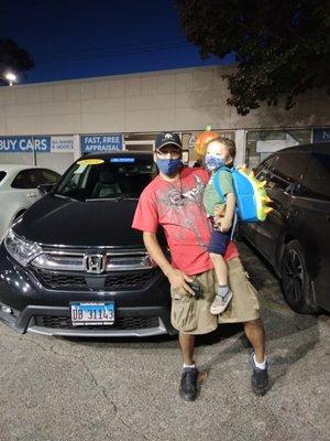 Santos and Sammy smiling in front of our new vehicle at North City Honda