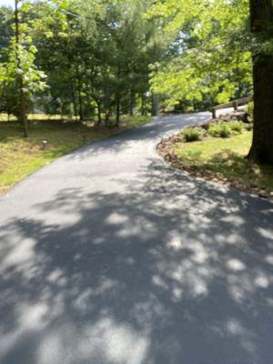 They sealed the cracks with rubber crack filling and then seal coated the driveway.