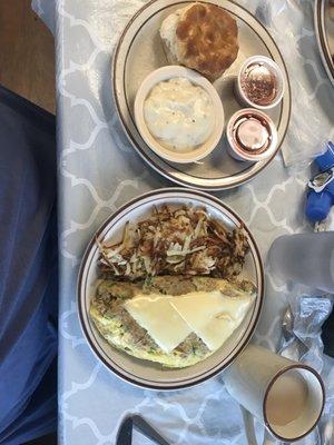 Philly steak omelet with hash browns and side of biscuit and gravy.