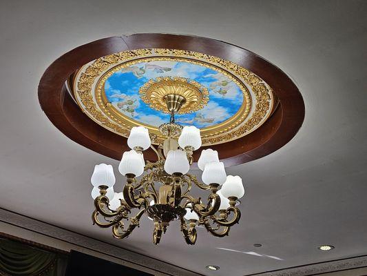 Chandeliers adored the ceiling with mural painting Cherubs