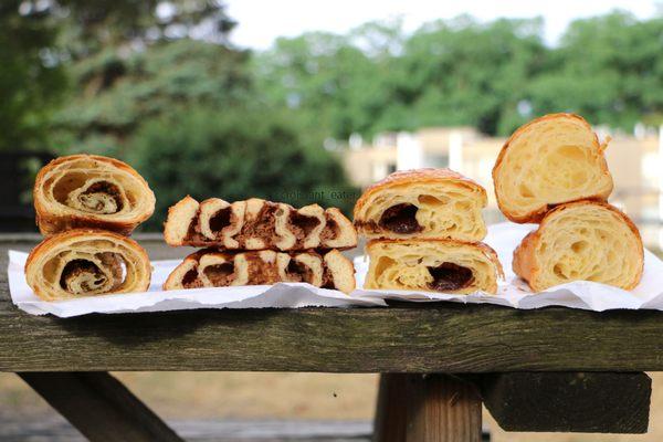 Insides of zaatar croissant, cinnamon roll, pain au chocolat, croissant (left to right)