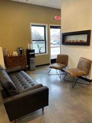 Waiting area with complimentary water and coffee.