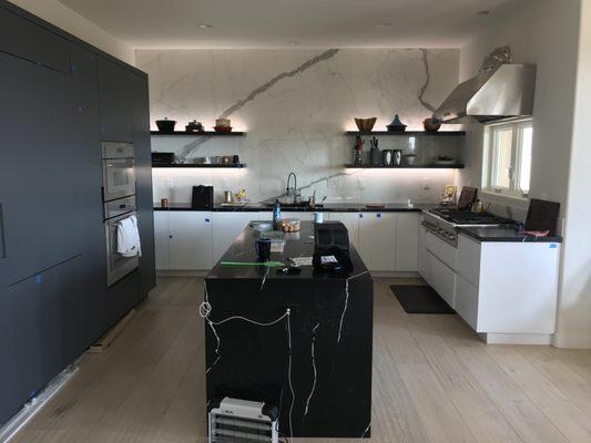 Modern kitchen with 1/4" porcelain slabs on the walls