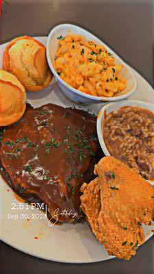 Smothered Pork chop with Red Beans and Rice Mac n cheese, and cornbread. I also added a wing