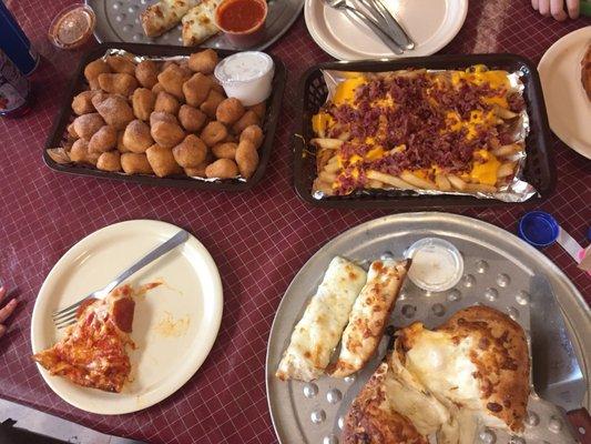 Cinnamon poppers with icing, bacon cheese fries, cheesy bread, chicken wing roll with AAALLLL THE CHEESE!!