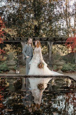 Bride and Groom autumn wedding pergola veil eclectic Gothic wedding with koi pond reflection