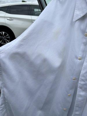 Stains on front of shirt starting at collar.